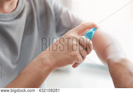 Asia Man Is Spraying Alcohol To Arm For Cleaning From A Cat Scratch Wound And Disinfection In First 