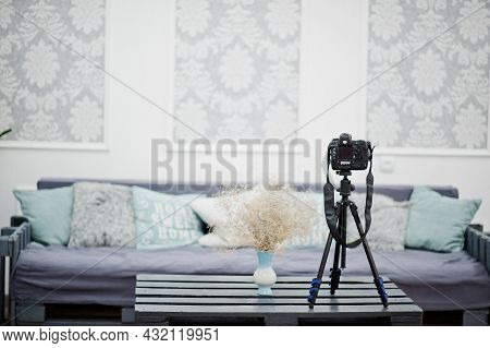 Camera On A Tripod In Cozy Bedroom Interior.
