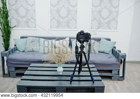 Camera On A Tripod In Cozy Bedroom Interior.