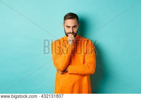 Thougtful Young Man Making Decision, Looking Serious And Thinking, Choosing, Standing Near Copy Spac