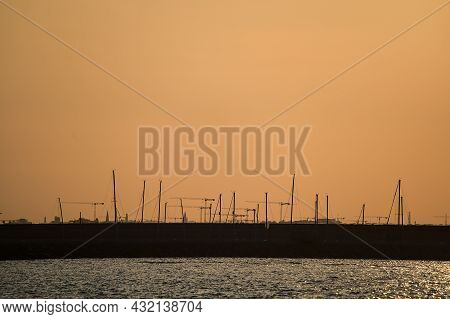 Beautiful Telephoto View Of Many Construction Cranes During Epic Orange Sunset Over Dublin Seen From