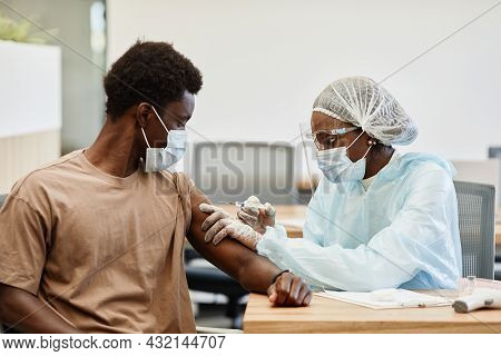 Young African-american Man Getting Second Shot Of Covid-19 Vaccine In Hospital