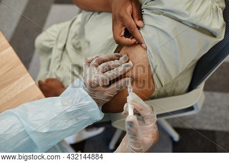 Hands Of Medical Nurse In Protective Gloves Giving Shot Of Vaccine In Clinic Or Hospital