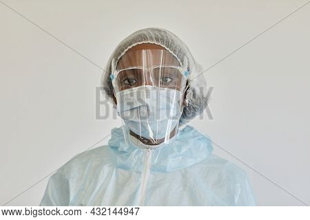 Portrait Of Sad Serious Medical Nurse In Ppe Suit Looking At Camera, She Is Tired After Day Of Work