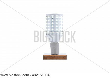 E27 230v Screw-cap Led Energy-saving Lamp On A Wooden Base Isolated On White Background.