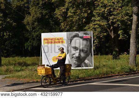 Duesseldorf, Germany - September 02, 2021: Advertising posters and banners for German federal election. Poster. Postman on FDP poster background
