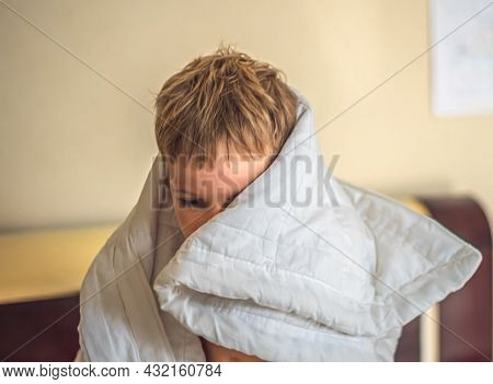 Close-up Front View Child Caucasian Boy Head Grey Hair Stick Out From White Blanket In Bedroom. Qual