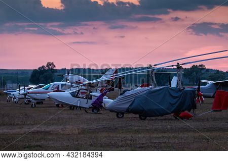 Shrouded Gyroplanes And Small Private Aircrafts At The Airfield In The Evening Light