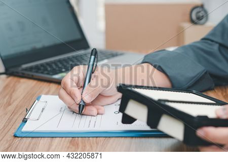 Car Service Staff Writing On The White Paper Clip File Board And Hold Car Air Engine Filter For Chec