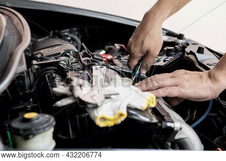 Car Technician Man Use Screwdriver Remove Bolt In Engine Room Service And Maintenance Concept
