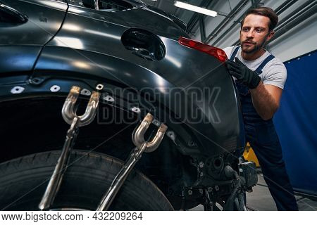 Vice Grips Locked To Car Frame While Mechanic Inspecting Taillight
