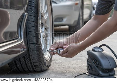 Asia Man Use Tire Gauge Analog Check Air Pressure Of Wheel Car On The Road Basic Maintenance By Ones
