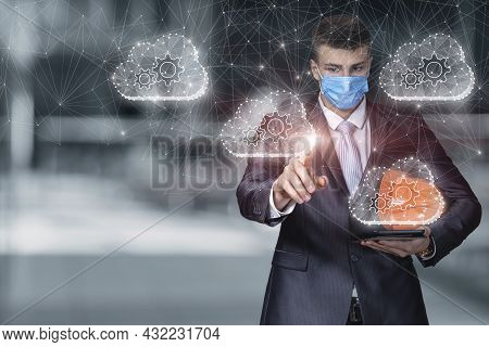 An Engineer In A Protective Mask Works With A Database On A Virtual Screen In The Network.