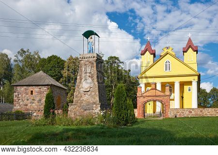 Old Ancient Wooden Catholic Trinity Church And Bell Tower In Daniushevo, Grodno Region, Belarus.