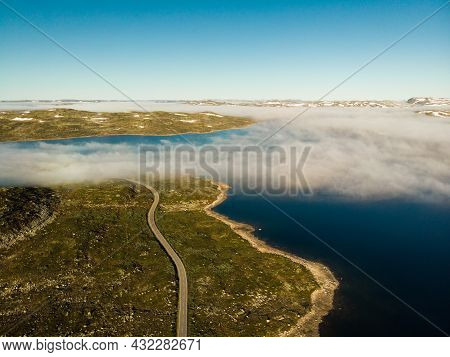 Aerial View. Road Crossing Hardangervidda Mountain Plateau, Clouds Over Lakes, Morning Time. Norway 