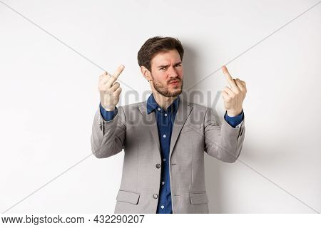 Rude Businessman In Suit Showing Middle Finger, Fuck You Gesture, Look Annoyed And Pissed-off, Stand