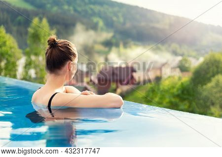 Back View Young Adult Female Person Enjoy Relax In Infinity Edge Luxury Outdoor Swimming Pool Lookin