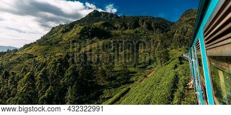 Travel By Train, Panorama. Road Trip. Blue Sri Lankan Train Goes Through Jungles, Trees, Wood, Mount