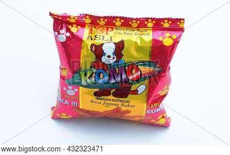 Kaliwungu, Indonesia - 5 September 2021: Snack Komo. Grilled Corn Flavored Snacks On A White Backgro