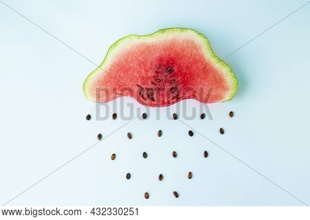 Watermelon Rain, Slice Of Watermelon In The Shape Of A Cloud With Seeds As Raindrops. Autumn Or Summ