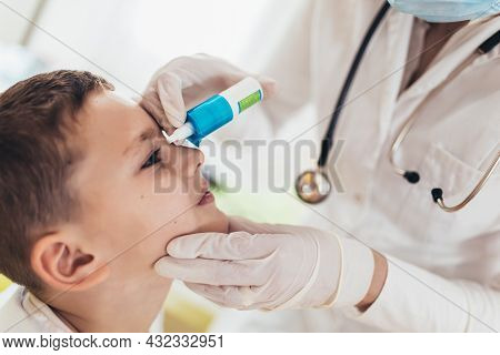 Closeup Of Doctor Pouring Eye Drops In Eye Her Little Patient.