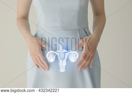 Unrecognizable Female Patient In Blue Clothes, Highlighted Handrawn Uterus In Hands. Human Reproduct