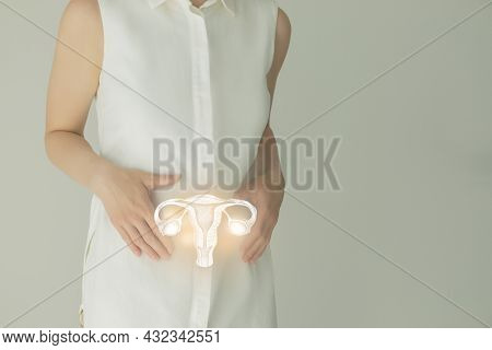 Unrecognizable Female Patient In White Clothes, Highlighted Handrawn Uterus In Hands. Human Reproduc