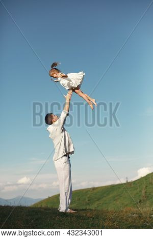 Father Playing With Ittle Daughter In A Mountains