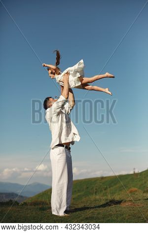 Father Playing With Ittle Daughter In A Mountains