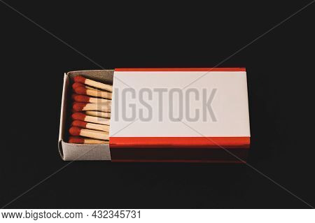 An Open Matchbox With A Blank White Label On A Black Table.