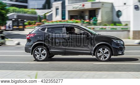 Nissan Qashqai Second Generation J11 Rides On City Road. Overspeed In City Concept. Black Suv Speed 