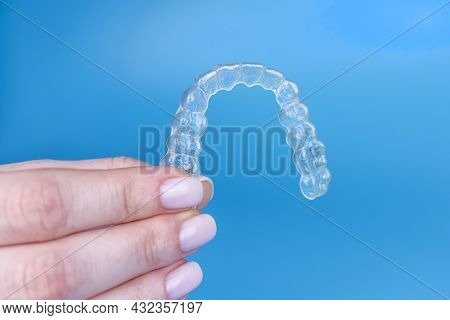 Hand Holding Removable Invisible Transparent Aligner Invisalign Or Plastic Orthodontic Braces Retain