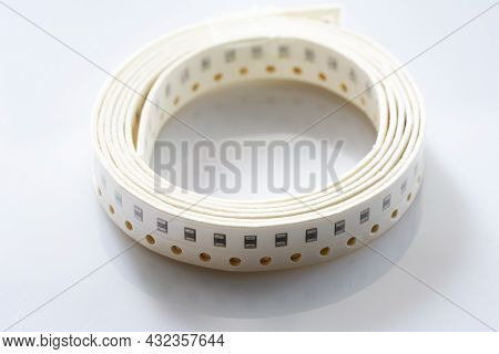 Electronic Component On White Background. Smd Components In Black Plastic Carrier Tape With Copyspac