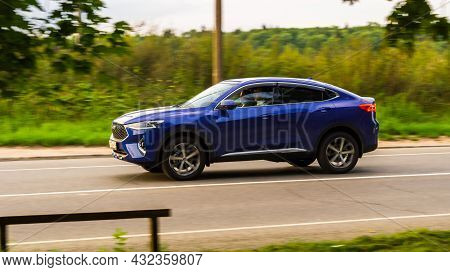 Haval F7x Five Door Suv Is Driving At High Speed On Country Road. Overspeed Out Of City Concept. Blu