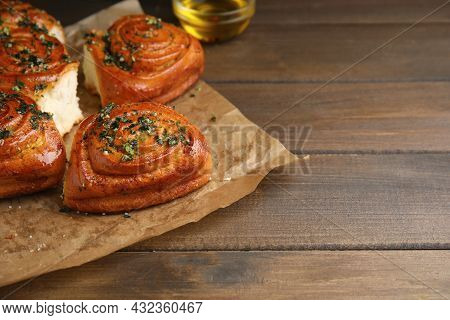 Traditional Ukrainian Bread (pampushky) With Garlic On Wooden Table, Space For Text