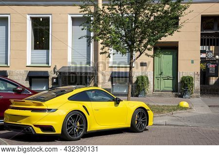 St. Petersburg, Russia - July 09, 2021: Yellow Sports Car In Parking Near The House In St. Petersbur