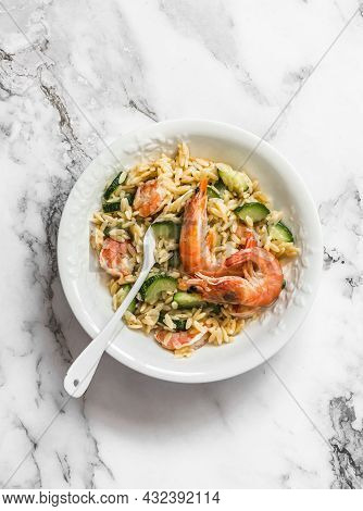 Delicious Mediterranean Lunch - Creamy Orzotto With Shrimp And Zucchini On A Marble Table, Top View