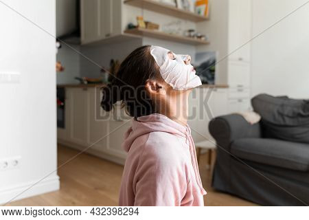 Young Woman With Beauty Mask At Home. Snackable Wellness Concept. Relaxation At Home For Young Mothe