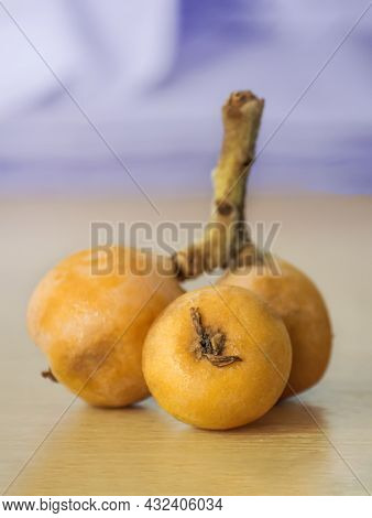 Ripe Medlar Or Japanese Eriobotria On The Table