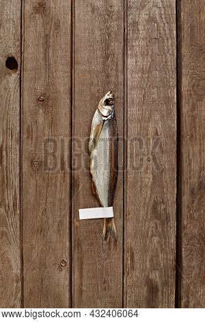 Air-dried Sabrefish With Label On Tail On Wooden Background