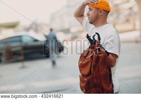 Young Disabled Man Hold Backback Leather Bag With Artificial Prosthetic Hand In Casual Clothes
