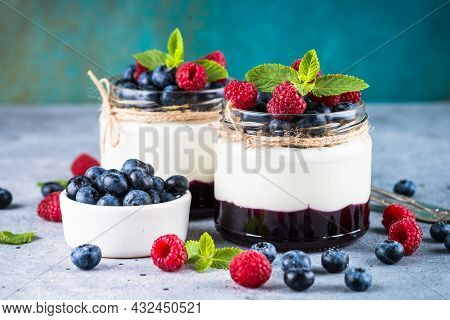 Parfait With Cream And Fresh Berries In The Glass Jar.