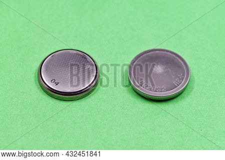 Used Coin Cell, Button Cell Or Cr2032 Lithium 3v Clock Battery On Green Background