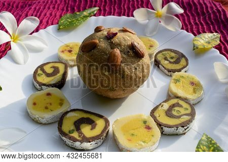 Indian Sweets Wheat Or Atta Laddu, Chocolate Barfi, Tutti Fruity Burfi Arranged On White Background.