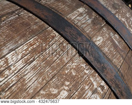 A Traditional Old Wooden Barrel With Curved Walls And Metal Hoops. Dishes For The Ripening Of Alcoho