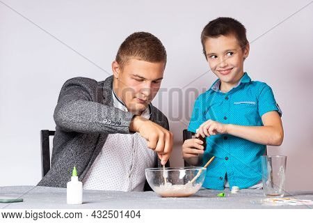 Chemistry Education And Training Concept. Close-up Of A Boy And His Dad Doing A Home Chemical Experi