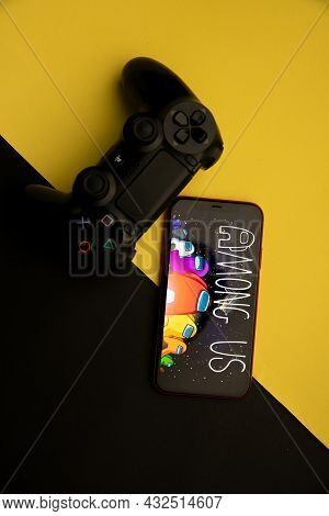 Tula, Russia - April 08, 2021: Among Us Logo On Iphone Display And Ps Gamepad