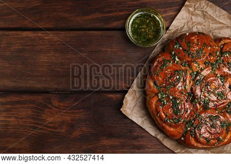 Traditional Ukrainian Garlic Bread With Herbs (pampushky) And Aromatic Oil On Wooden Table, Flat Lay