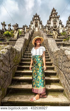 Woman Traveler At Ancient Gate At Pura Penataran Agung Lempuyang Temple On Bali, Indonesia