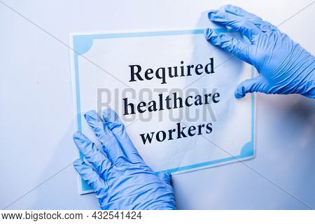 Doctor Or Nurse Pasting Required Helathcare Workers Infront Of Hospital Door During Coronavirus Or C